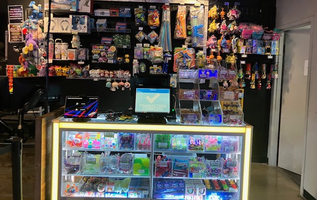 The glowing Nitro Vault prize counter at Amped Arcade Fairfield, stocked with ticket-priced toys and candy