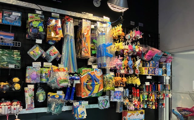 The Nitro Vault prize wall at Amped Arcade Fairfield, hung with blasters, plushes, and keychain prizes