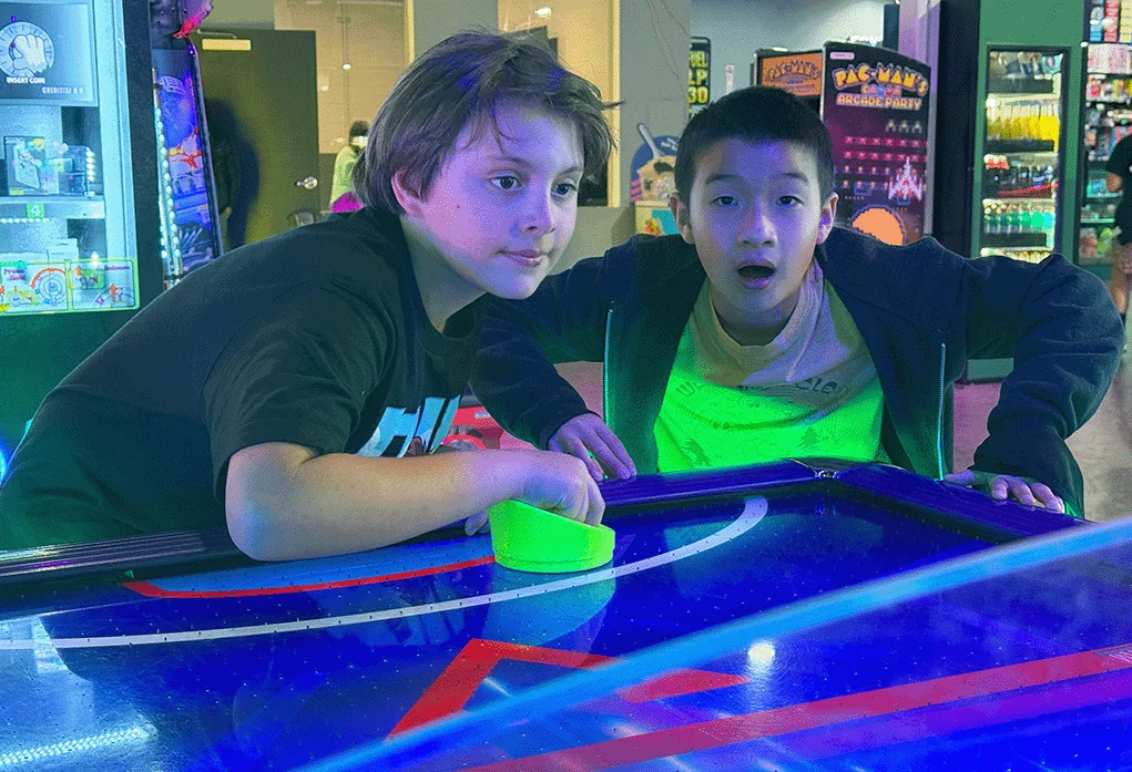 Guests playing air hockey inside Amped Arcade at Nitro City Racing Rohnert Park