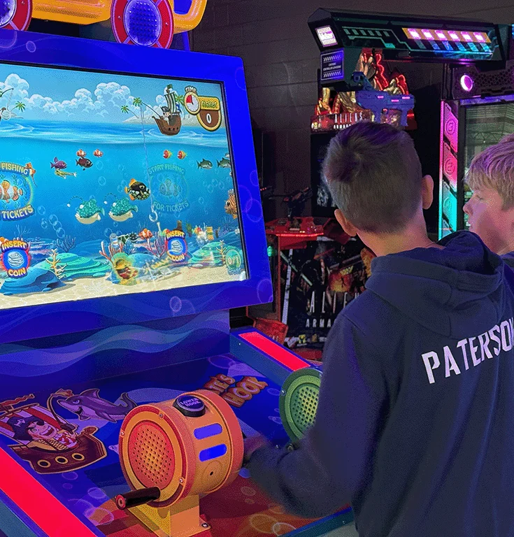 A guest playing an arcade cabinet at Amped Arcade Rohnert Park