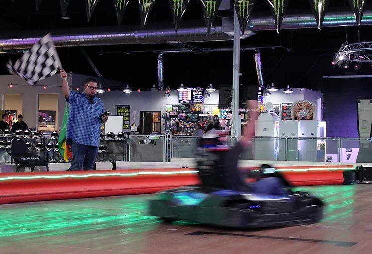 A kart racing past the flag stand at Nitro City Racing Rohnert Park