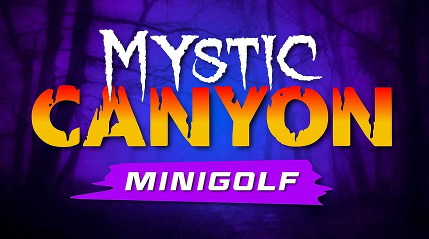 Mystic Canyon blacklight mini golf entrance sign at Nitro City Racing Fairfield