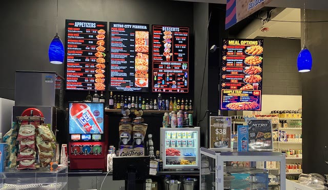 The Nitro Cafe counter at Fairfield with menu boards, drink machines, and the grab-and-go case
