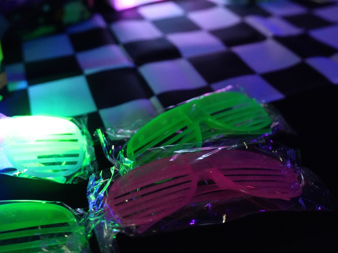 Neon glow shades waiting at each place on the party table
