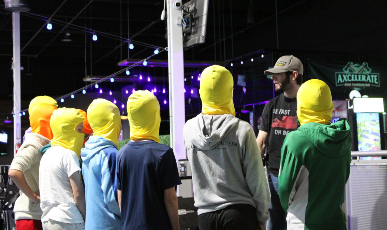 Party crew in racing headsocks getting the pre-race briefing at Nitro City Racing